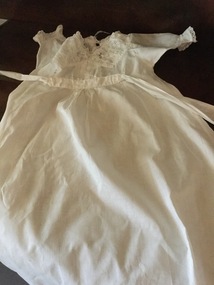 A white cotton and lace child's nightgown.