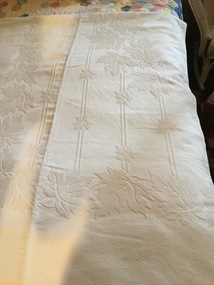 A single bed white self embossed cotton bedspread.