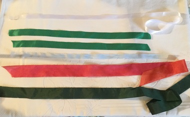 Six satin and nylon hair ribbons: red, dark green, pale blue, white and emerald. 