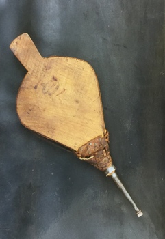 A pair of wood and leather bellows for starting to light a fire.