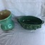 A set of five pieces of green ornamental china with grapes and leaf designs. Included are two bowls a jug and two vases. 