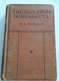 Small brown hardcover logbook with the title The Man from Oodnadatta by R.D. Plowman set in black lined design.