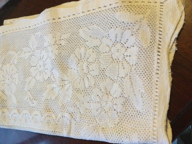 White cotton broderie anglaise curtain with feature embroidery, cutwork and needle lace. 