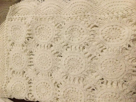 Four white rectangular crocheted table runners.