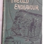 Cover of book shows a shipwreck with men pointing to it in the distance with others unloading goods on the wharf. The title The Old Endeavour is written in gold lettering at the top.