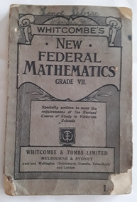 The grey covered textbook Whitcombe's New Federal Mathematics is very badly damaged with torn front and back covers. Lance Sebire Wandin Yallock is written at the top of the front cover