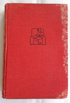 A red fabric covered hardcover novel with a black outline of a boy sitting on a couch reading a book.
