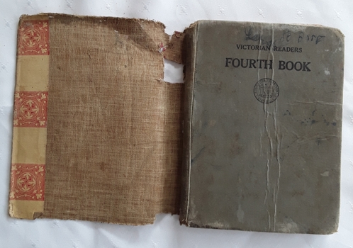 An old grey hardcover Victorian Readers Fourth Book for use by students in Victorian Primary Schools