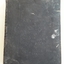 A faded black copy of The Holy Bible containing the Old and New Testaments.