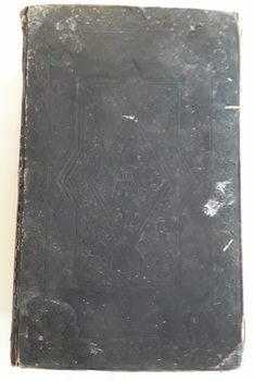 A faded black copy of The Holy Bible containing the Old and New Testaments.