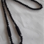 A mid length black necklace made of Jet gemstones of varying sizes in the c.1940's.