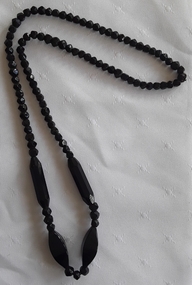 A mid length black necklace made of Jet gemstones of varying sizes in the c.1940's.