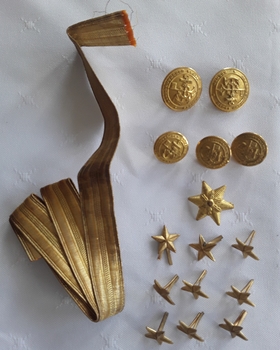 A set of 10 rolled gold stars, 5 buttons and a piece of gold thread ribbon for wearing on a German military uniform in WW1.