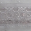 A small narrow Windsor cut clear glass container used in the bedroom.