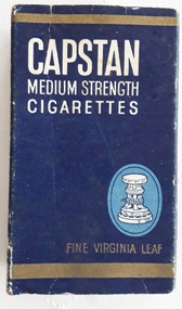 A small blue, gold and white cardboard Capstan Cigarette packet which contained 10 medium strength cigarettes.