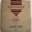 A vintage gold square Statesman Lancers 10 cigar tin with red and black stripes at the top. 