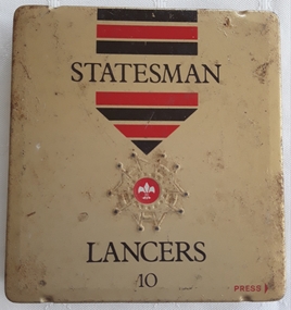 A vintage gold square Statesman Lancers 10 cigar tin with red and black stripes at the top. 