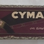 A purple decorated ladies CYMA watch in its case.