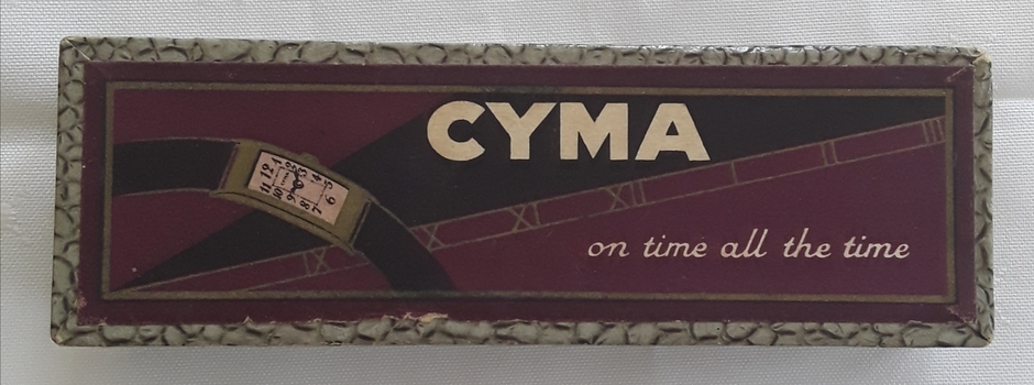 A purple decorated ladies CYMA watch in its case.