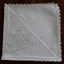 Seven white square Richelieu cutwork cotton serviettes with Filet Lace borders for use when dining.