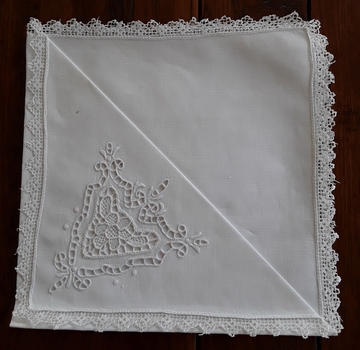 Seven white square Richelieu cutwork cotton serviettes with Filet Lace borders for use when dining.
