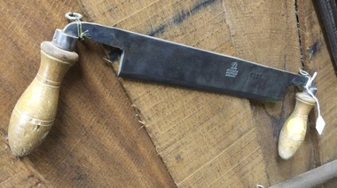 A straight bladed woodworking tool used to trim handles or shave wood