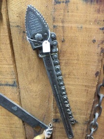 A metal wrench with chain  used to tighten metal pipes.