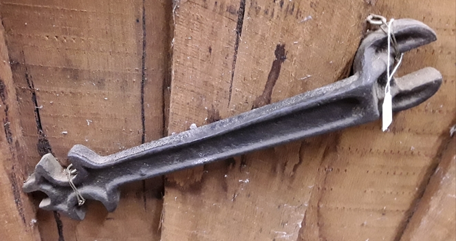 A double headed plough spanner with three spanners at one end.