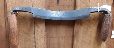 A steel curve bladed, two handled draw knife used to shave wood.
