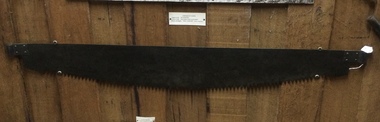 A steel  fine toothed crosscut saw with no handles