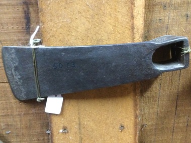 A forged steel axe head used to cut holes in timber.