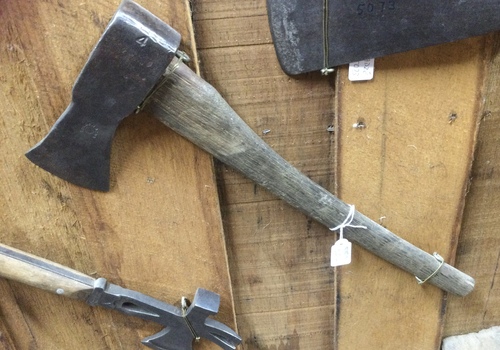 A forged steel headed hatchet with a handmade wooden handle.