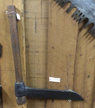 A forged steel headed paling knife with a wooden handle