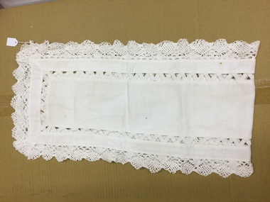 White table runner with some small rust stains. 