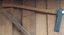An axe used for cutting holes on wooden posts where wooden rails are fitted.