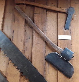 A steel forged wooden handled large broad axe used for squaring up posts and to shape timber.