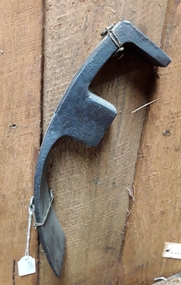 A forged steel Cooper's Adze with a curved blade used for trimming wood.