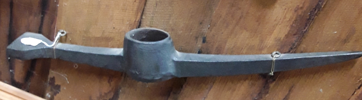 A forged steel Fettler's pick head used to maintain railway tracks circa 1900.