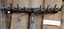 A hand used steel adjustable scarifier with a long wooden handle.