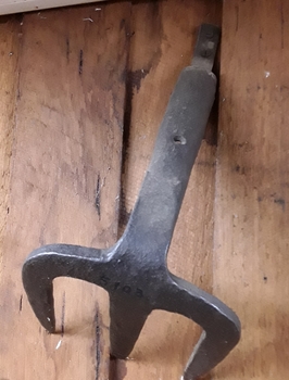 A blacksmith made steel three pronged fork hoe head.
