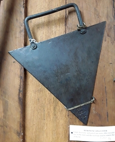A triangular steel kerosene tin cutter for opening kerosene or petrol tins.