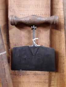 A small steel meat chopper with a turned wooden handle.