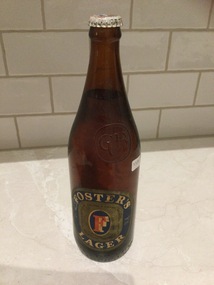 Brown glass Fosters Lager beer bottle.