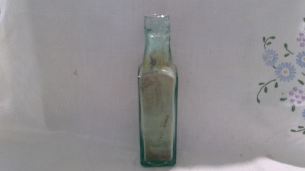 Green bottle with missing lid. Very long in length.
