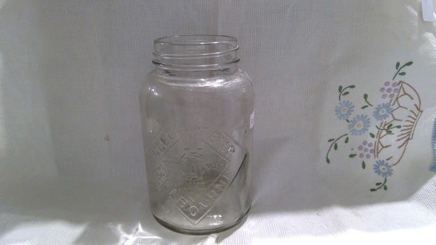 Glass jar with a missing screw top lid.