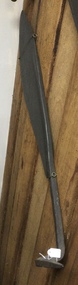 A large steel curved bladed silage or hay knife with a tapered handle and a bent pointed sharp end.