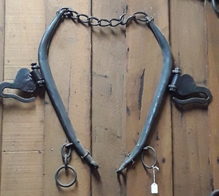 A pair of tubular steel horse hames which are linked together by a five links chain at the top to two rings.