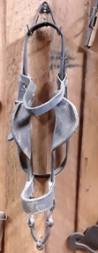 A pair of vintage leather horse winkers with steel rings, a bit and bars and side leather buckles to attach it to the cheek straps.