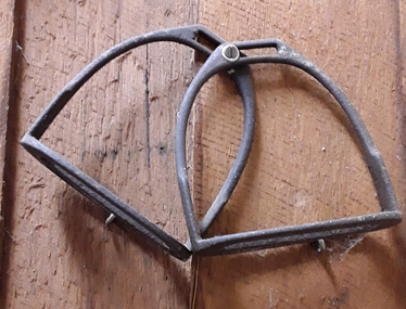 A pair of curved steel riding stirrups which attach to each side of a horse's saddle.