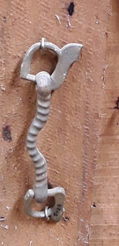 A decorative ribbed brass horse bit or mullen which is part of a horse's tack.